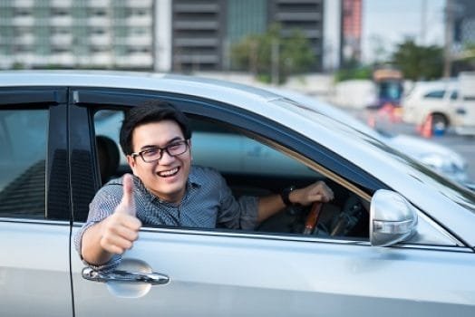 man smiling in a car 