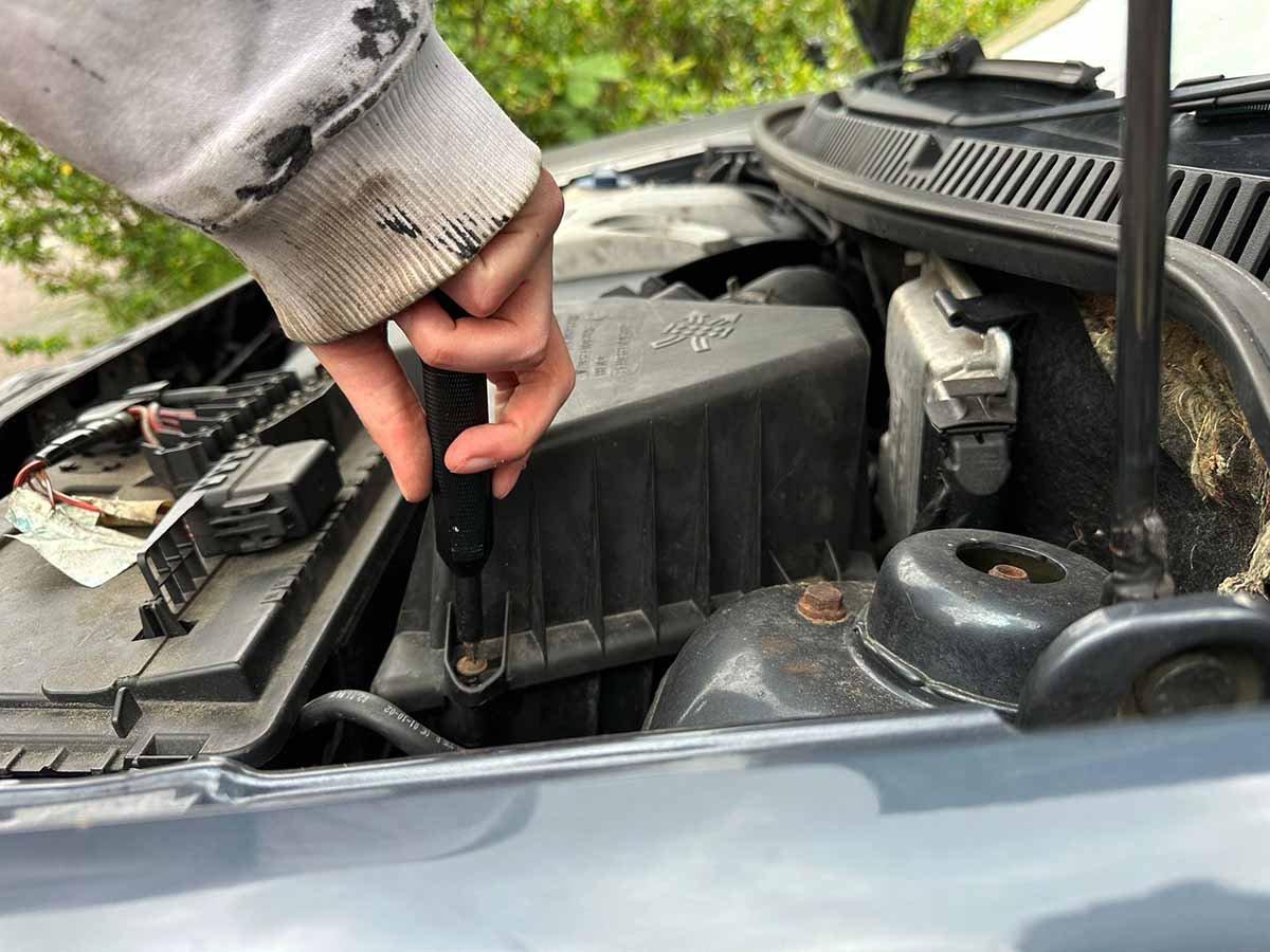 unscrew the air box cover